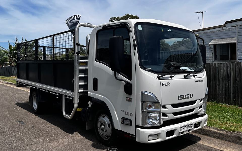 Isuzu NLR 45-150 tipper truck with a caged green waste body