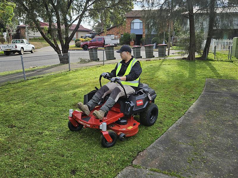Toro TimeCutter ride-on mowing a residential front lawn in Sydney